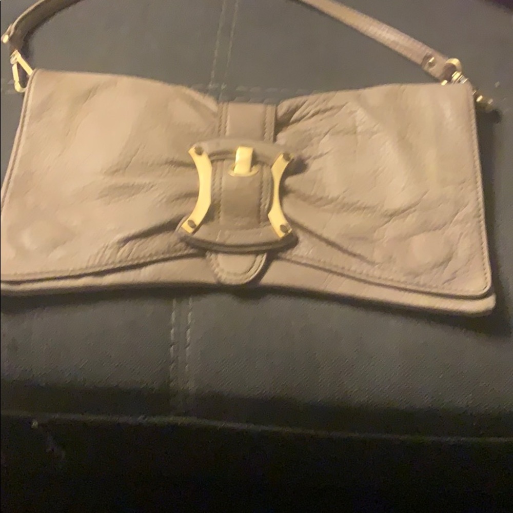 B. Makowsky leather clutch with strap